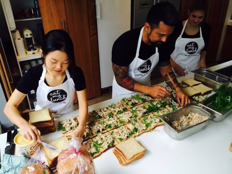 Three people preparing sandwiches for Eat My Lunch