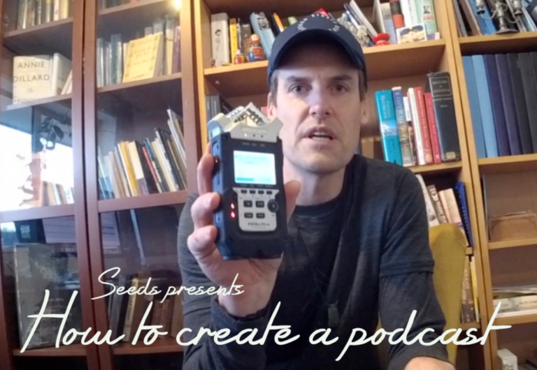 Steven Moe holding a voice recorder.
